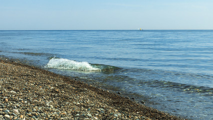 sailboats on the horizon are sailing on the blue sea