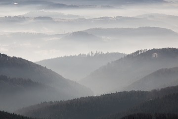 Fototapeta na wymiar Foggy morning hills in winter 