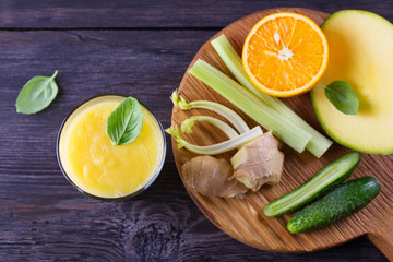 Obraz na płótnie Canvas Orange Mango Ginger Smoothie. Fruit and Vegetable Smoothie - healthy diet and detox drink