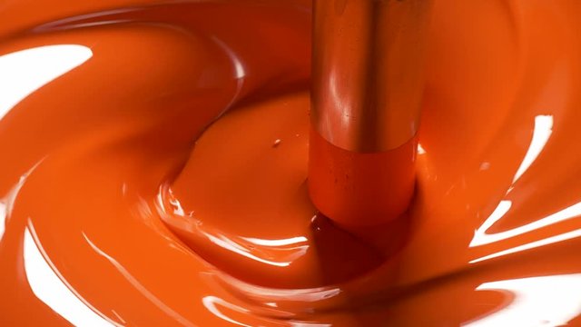 25fps4k Production and mixing of red oil paint in a large tank