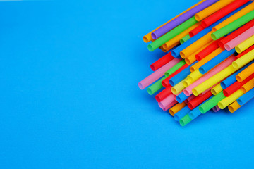 colorful of straw on blue paper with space background