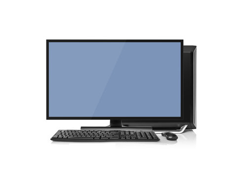 Modern desktop computer with wireless keyboard and mouse isolated on white.