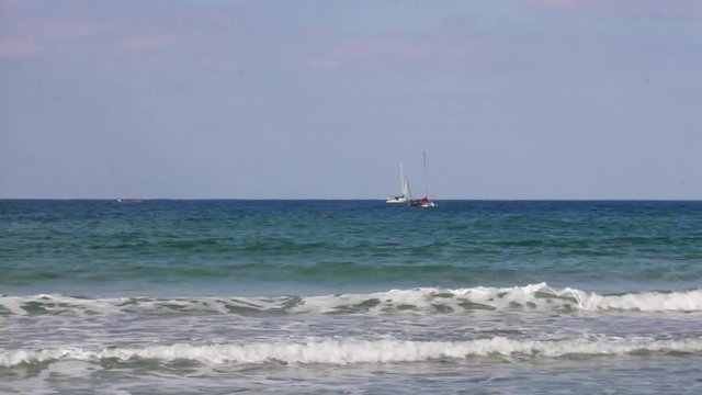 Small white yachts with sail moving on Mediterranean Sea