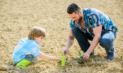 rich natural soil. Eco farm. new life. soils and fertilizers. small boy child help father in farming. father and son planting flowers in ground. happy earth day. Family tree. earth day. Successful