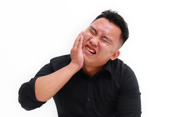 Young man suffering from toothache on white background, closeup