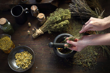 Homeopathy and herbal medicine. The woman prepares natural herbal medicines.