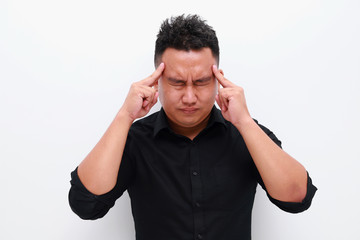 Naklejka premium Young man suffering from headache. Healthcare, pain, stress and people concept