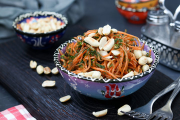 Carrot salad with peanuts in oriental style located in a bowl