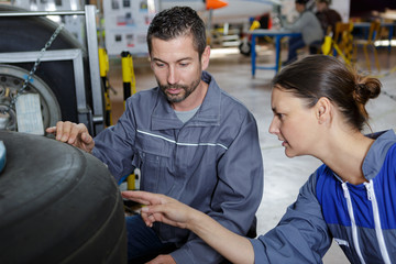 mechanics inspecting the aircraft tire