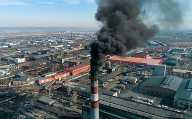 Carbon dioxide emissions. Black smoke of coal-fired plant. Aerial top view.