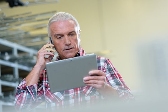 man on the phone using tablet pc - Powered by Adobe