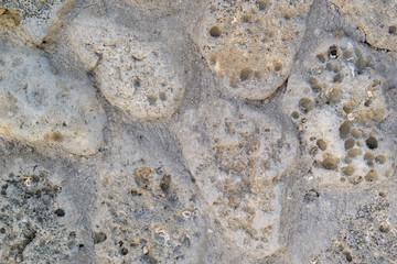 Gray stone wall of rough, natural stone, background texture.