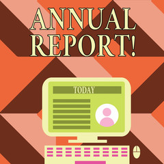 Writing note showing Annual Report. Business concept for financial summary of a company s is activities during the year Computer Mounted on Stand with Online Profile Data on Screen