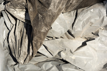Background of industrial plastic bags in the sand