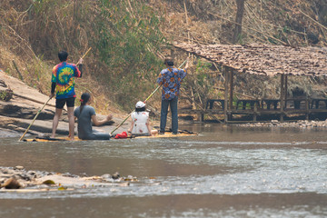 Bamboo rafting in green tropical scenery as a tour for tourist in Mae Wang District Chiang Mai Thailand