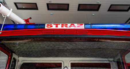 Obraz premium Blue warning signals placed on the roof in a fire truck with the Polish inscription 