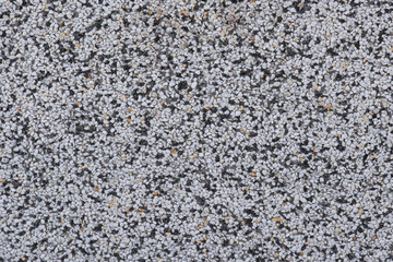 Background of small white and black rocks. Background and texture of small white and black rocks