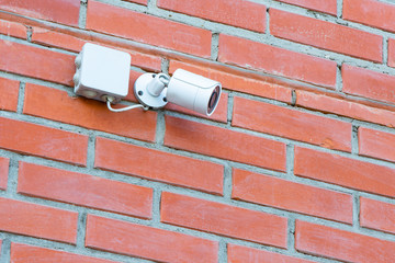 CCTV Security Camera. Security camera mounted on the outdoors brick wall.