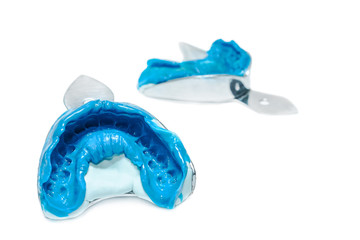 Two dental impressions on a white background with copy space. The imprint of the tooth row of high precision.