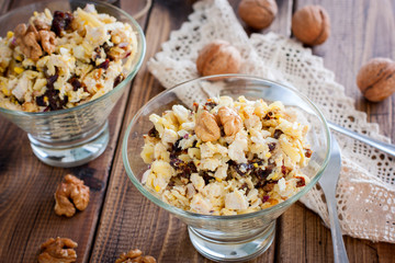 Festive salad of walnut, chicken and prunes in glass salad bowls, horizontal
