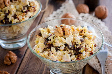 Festive salad of walnut, chicken and prunes in glass salad bowls, horizontal