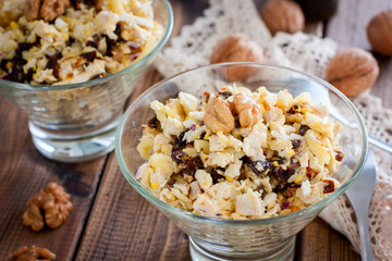 Festive salad of walnut, chicken and prunes in glass salad bowls, horizontal