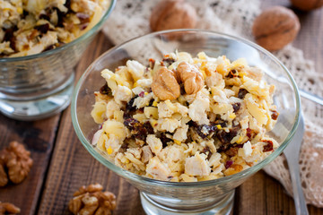 Festive salad of walnut, chicken and prunes in glass salad bowls, horizontal