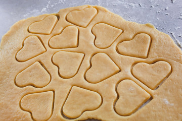 Dough. The process of making cookies and gingerbread at home. Heart-shaped cookies, pattern