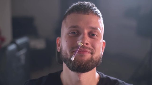 Hair removal. Man's face sugaring epilationsy ellow color, in cosmetology on the couch. hair removal inside the nose