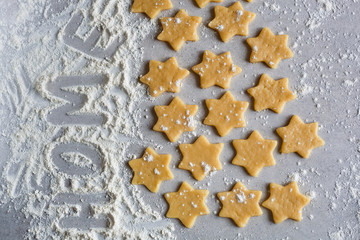 Cookies at home. Process. Seed biscuits in the form of stars. the inscription on the flour.Home