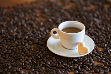 cup of coffee and beans on wooden table
