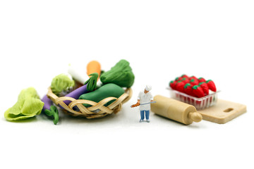 Miniature people : Chef with Assortment of fresh fruits and vegetables,cooking concept.
