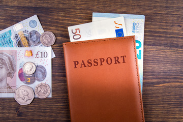 UK pound, euro money and passport. Travel to Great Britain concept. Money of United kingdom close-up on wooden background