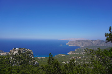  Picturesqueview on Monolithos castle perched atop a 100-meter tall sheer rock face overlooking the Mediterranean