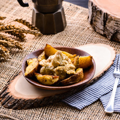 homemade potatoes and chicken on rustic background