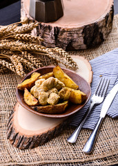 homemade potatoes and chicken on rustic background