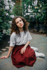 The young girl walks in a summer garden