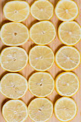 Fresh yellow lemons slices on a wooden background.. sweet lime, vitamin c. Lemon slices