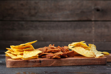 wide selection of snacks for beer on wooden background