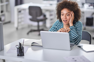 Cute mixed race businesswoman dressed  casual thinking how to solve a problem while sitting in...