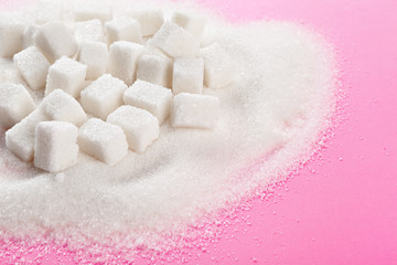 Fototapeta na wymiar Cubes of sugar on bright pink background
