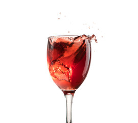 A glass of red wine on a white or black background with splashes.