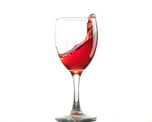 A glass of red wine on a white or black background with splashes.