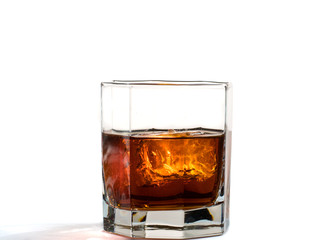 Fallen and falling whiskey glass with ice and splashes