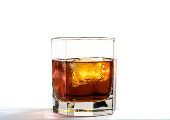 Fallen and falling whiskey glass with ice and splashes