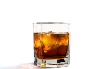 Fallen and falling whiskey glass with ice and splashes