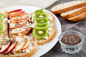 Healthy breakfast toasts with kiwi, apple, cottage cheese and chia seeds
