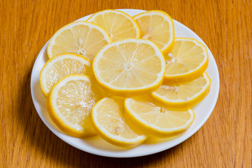Fresh yellow lemons slices on a wooden background.. sweet lime, vitamin c. Lemon slices