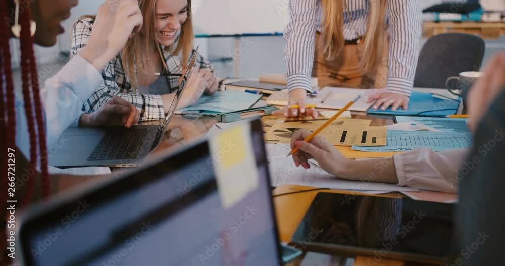 Wall mural Teamwork at multiethnic workplace. Close-up shot, hands of business people working together at modern office meeting.