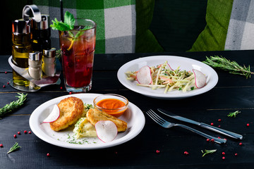 Two plates with the meal on the table, view from above